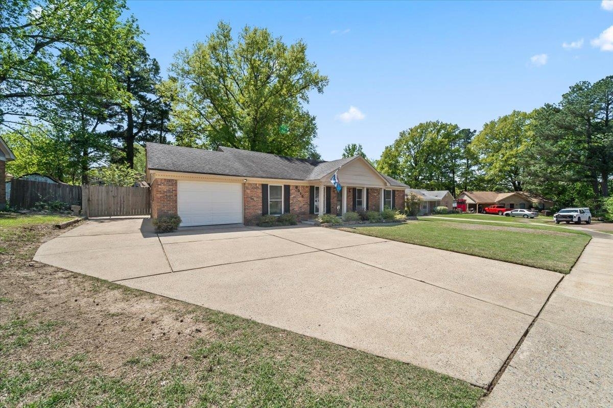 6315 Bardstown Road Bartlett, TN 38134 - Photo 4 of 31 Single story home featuring a garage, concrete driveway, and brick siding