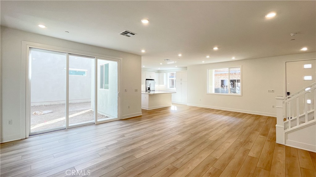 191 Junco Irvine, CA 92618 - Photo 6 of 31 a view of an empty room with wooden floor and a window
