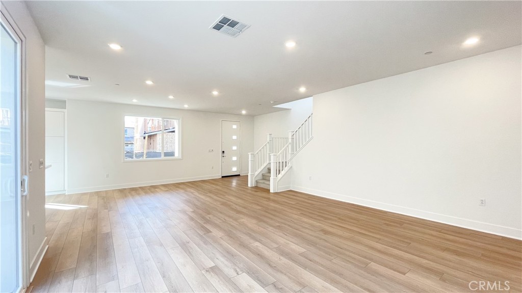 191 Junco Irvine, CA 92618 - Photo 7 of 31 an empty room with wooden floor and windows