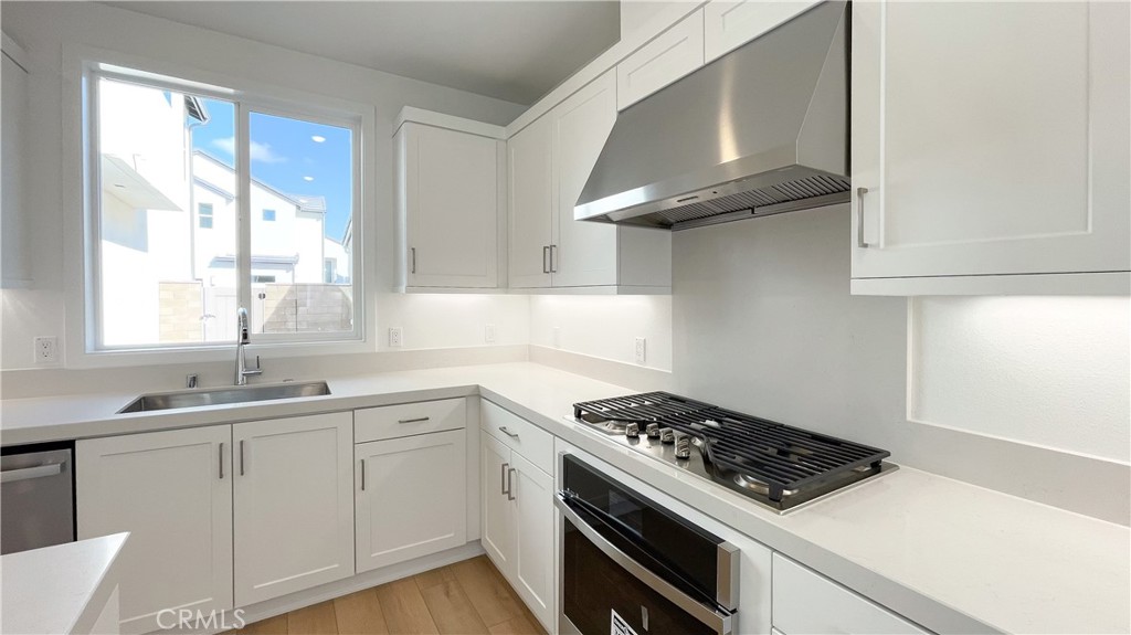 191 Junco Irvine, CA 92618 - Photo 10 of 31 a kitchen with cabinets and stainless steel appliances
