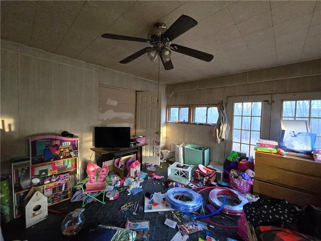 a room with furniture toys and a flat screen tv