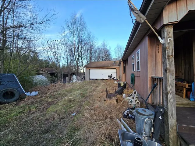 a view of a house with backyard and sitting area