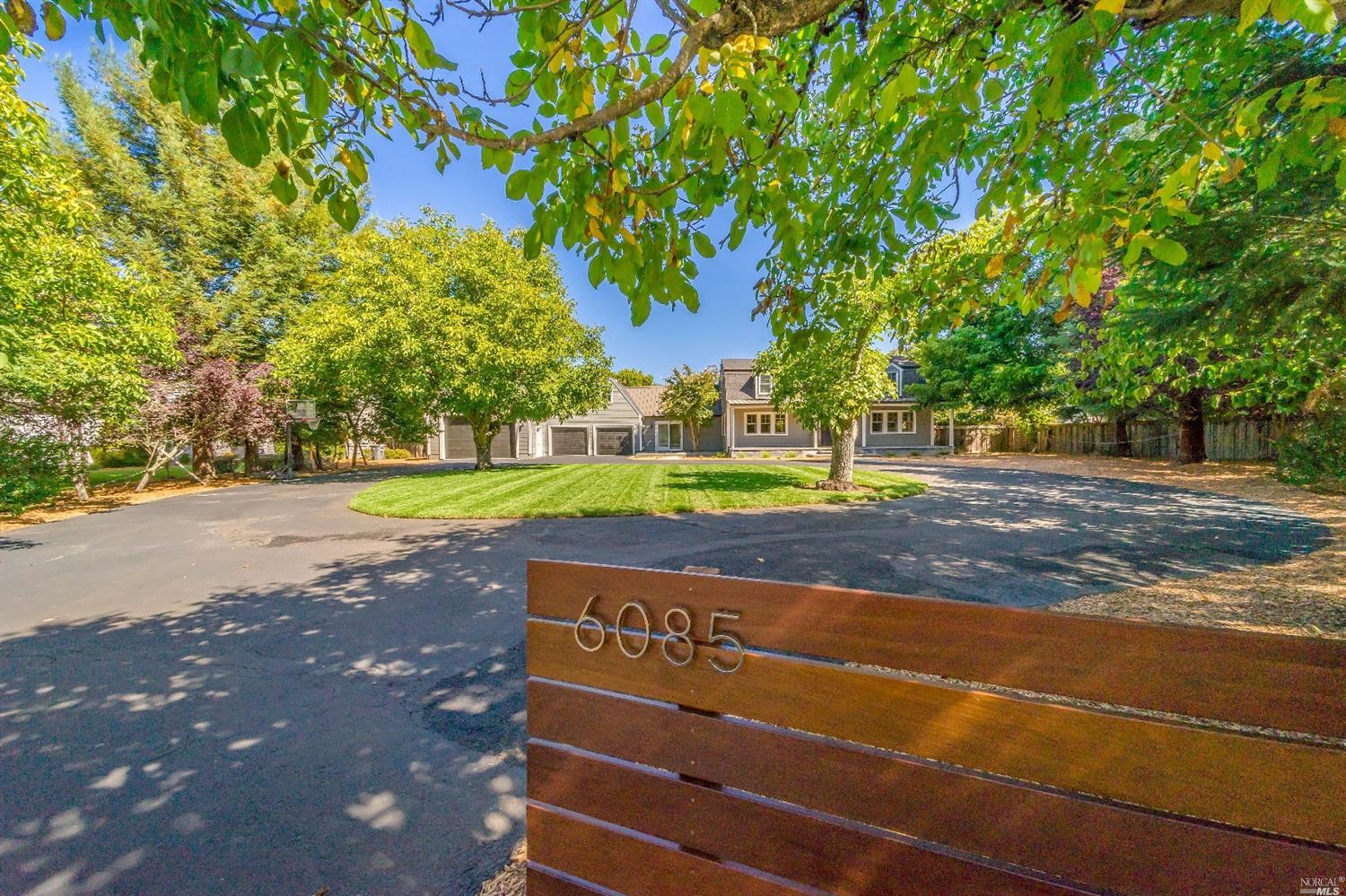6085 Melita Road Santa Rosa, CA 95409 - Photo 1 of 1 a view of a street with a house and large trees