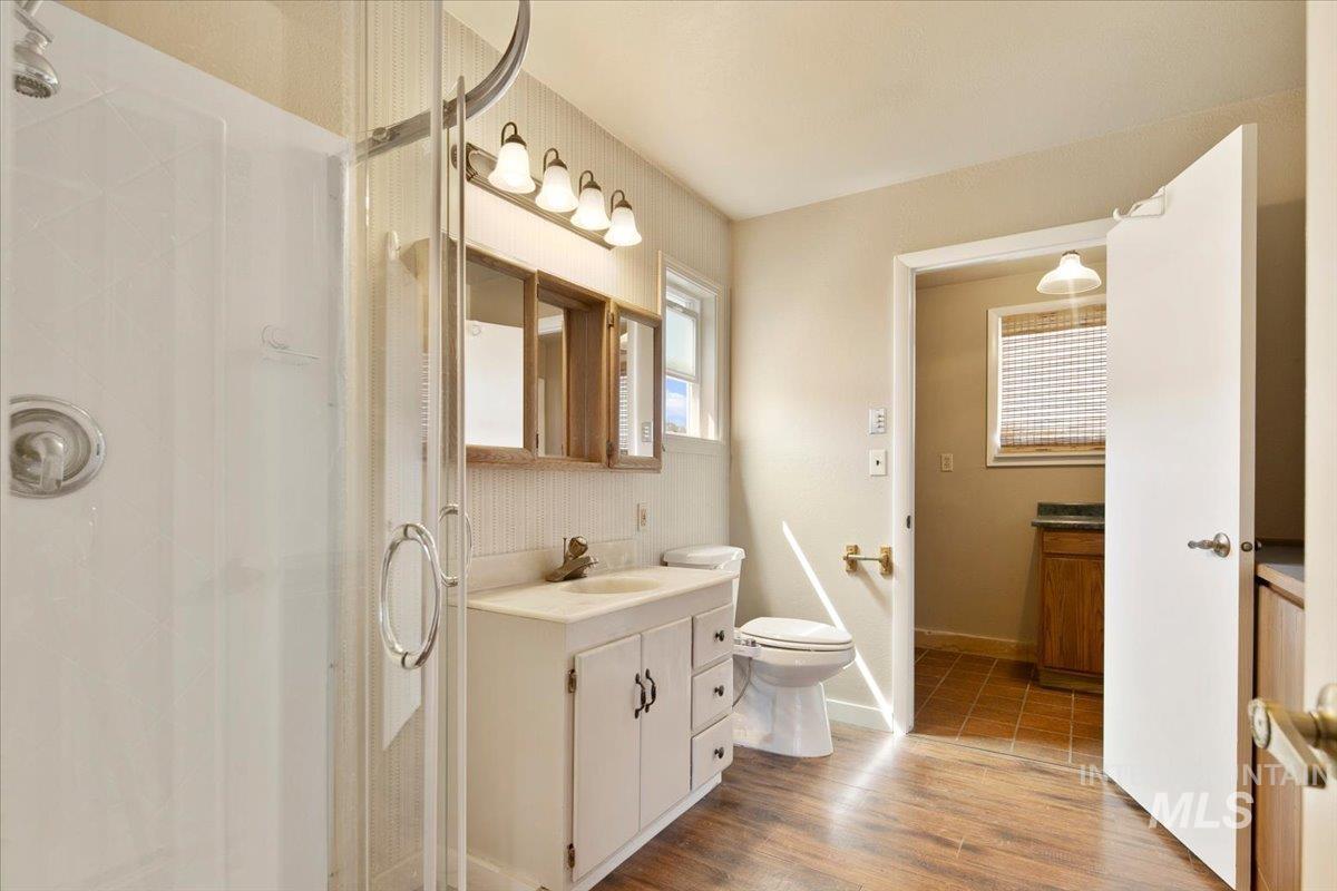 3617 Bowman Road Emmett, ID 83617 - Photo 25 of 50 Bathroom featuring a stall shower, vanity, and wood finished floors