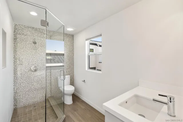 a bathroom with a sink a shower and a mirror