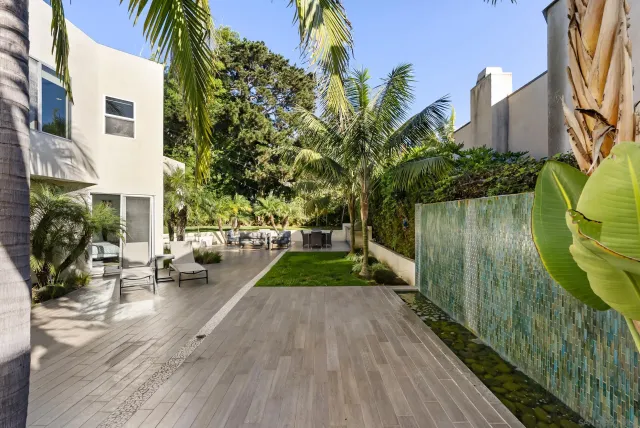 a aerial view of a house with a yard and potted plants