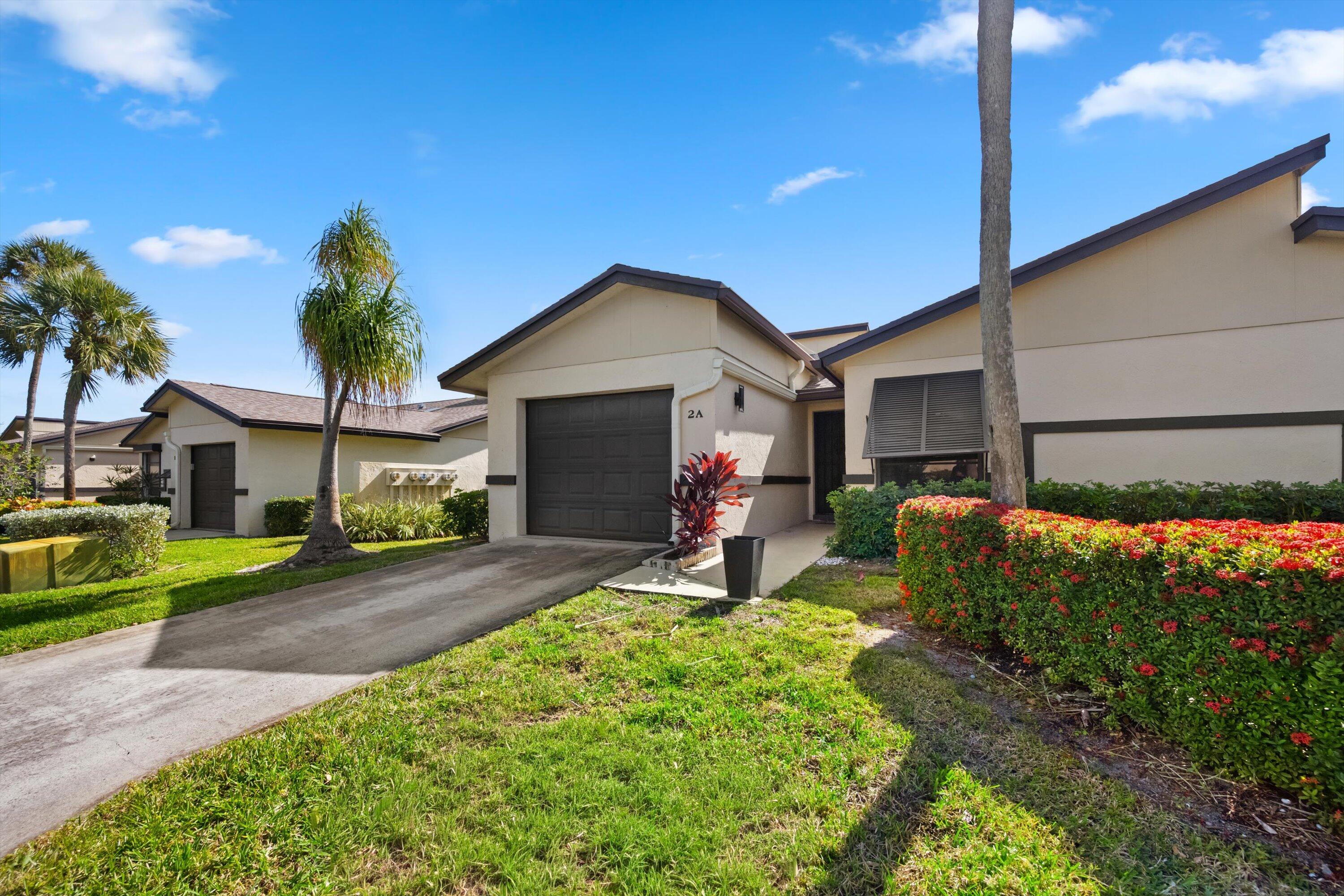 a front view of a house with a yard and outdoor seating