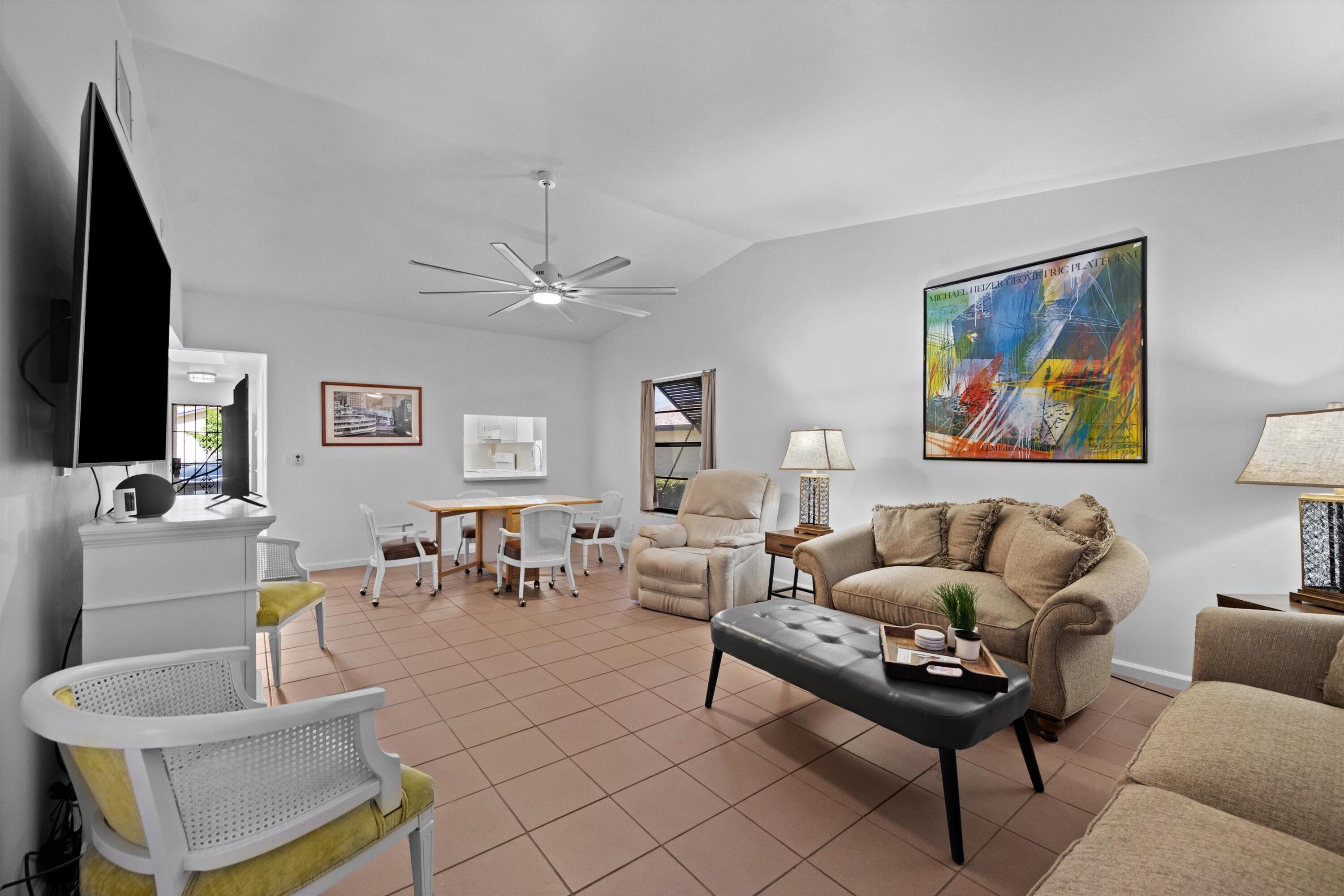 2 Ridge Pointe Drive, Unit A Boynton Beach, FL 33435 - Photo 11 of 24 a living room with furniture and a flat screen tv