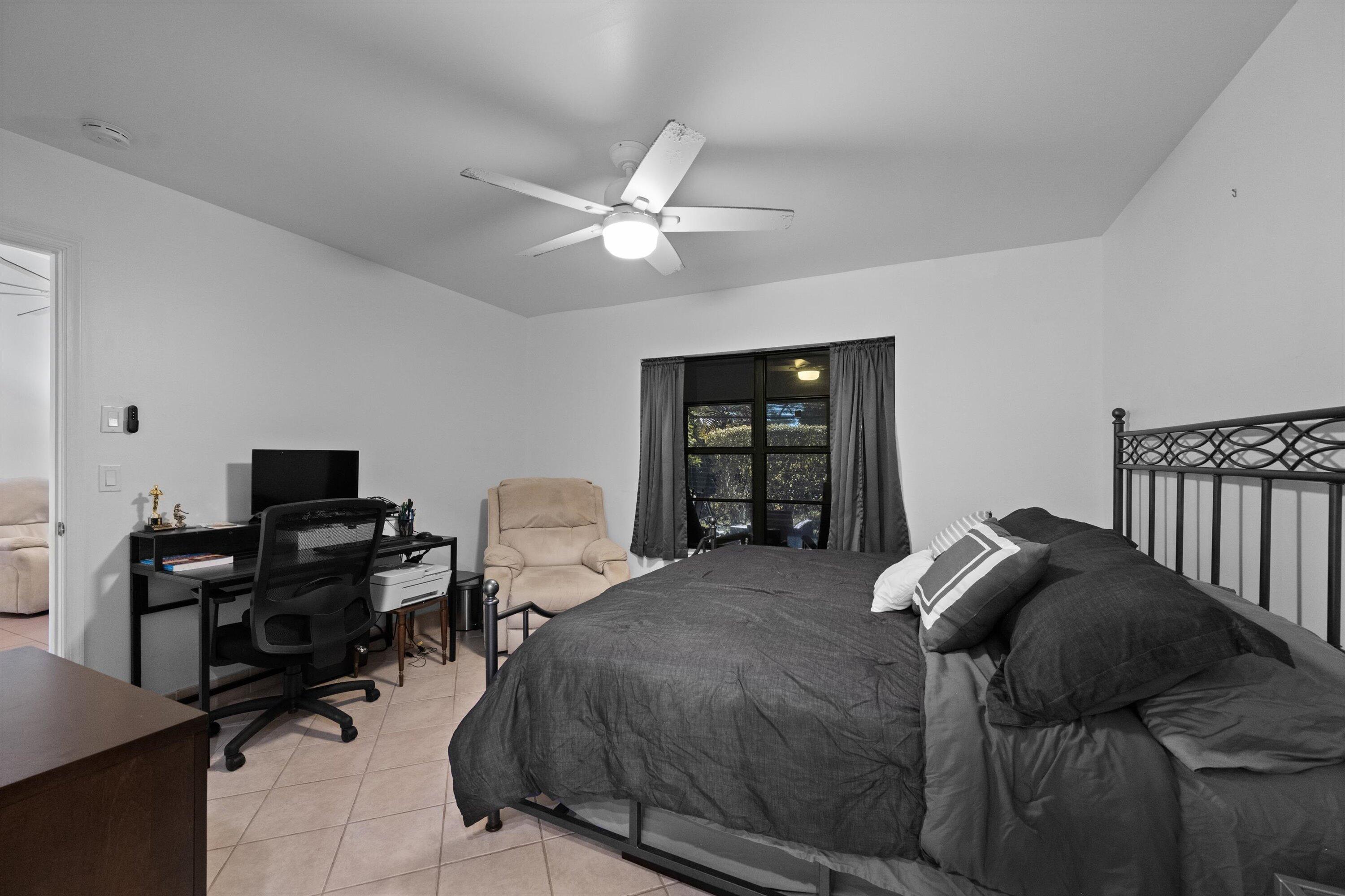 2 Ridge Pointe Drive, Unit A Boynton Beach, FL 33435 - Photo 13 of 24 a bedroom with a bed and a window