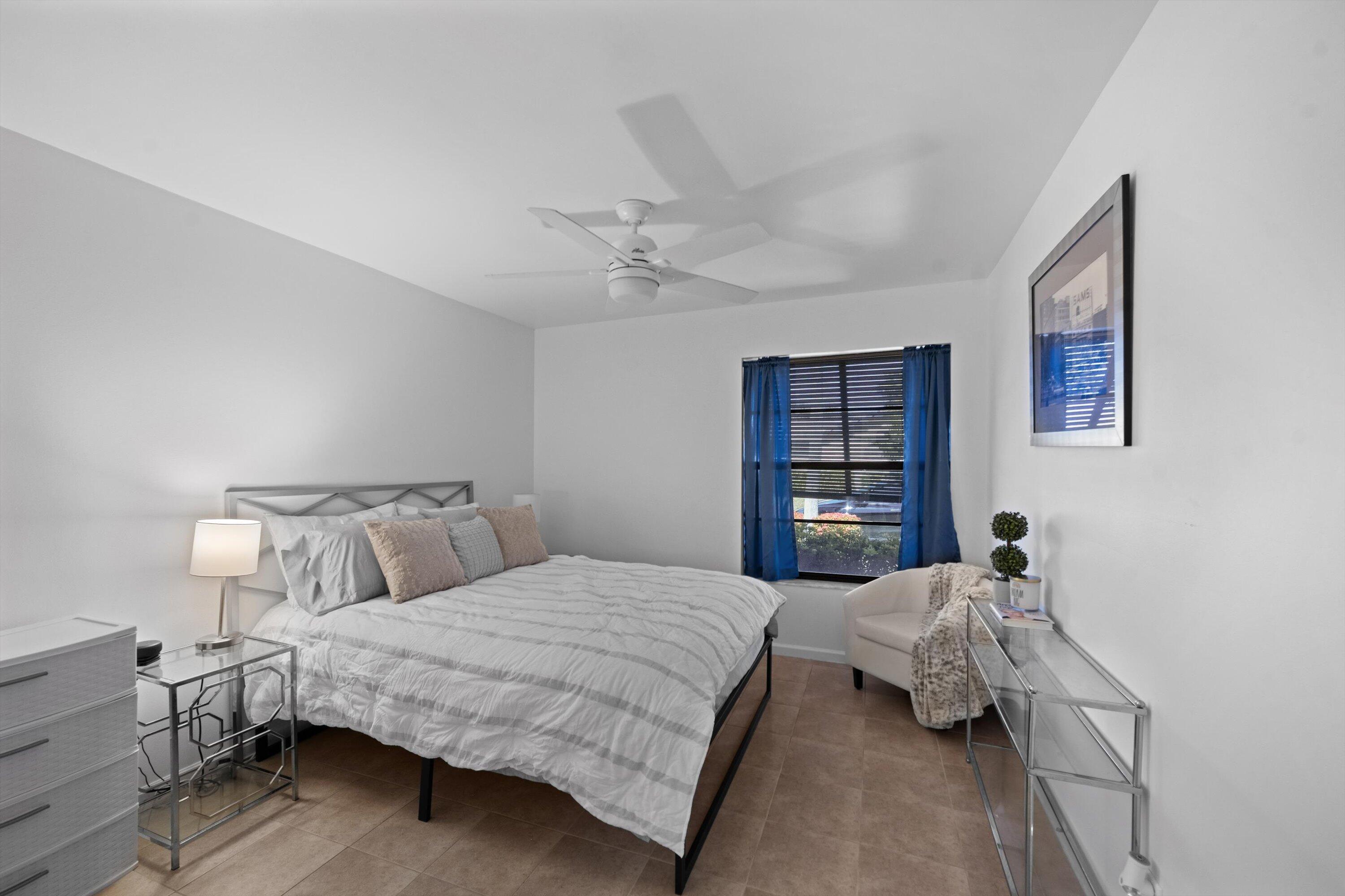 2 Ridge Pointe Drive, Unit A Boynton Beach, FL 33435 - Photo 17 of 24 a bedroom with a bed and a window