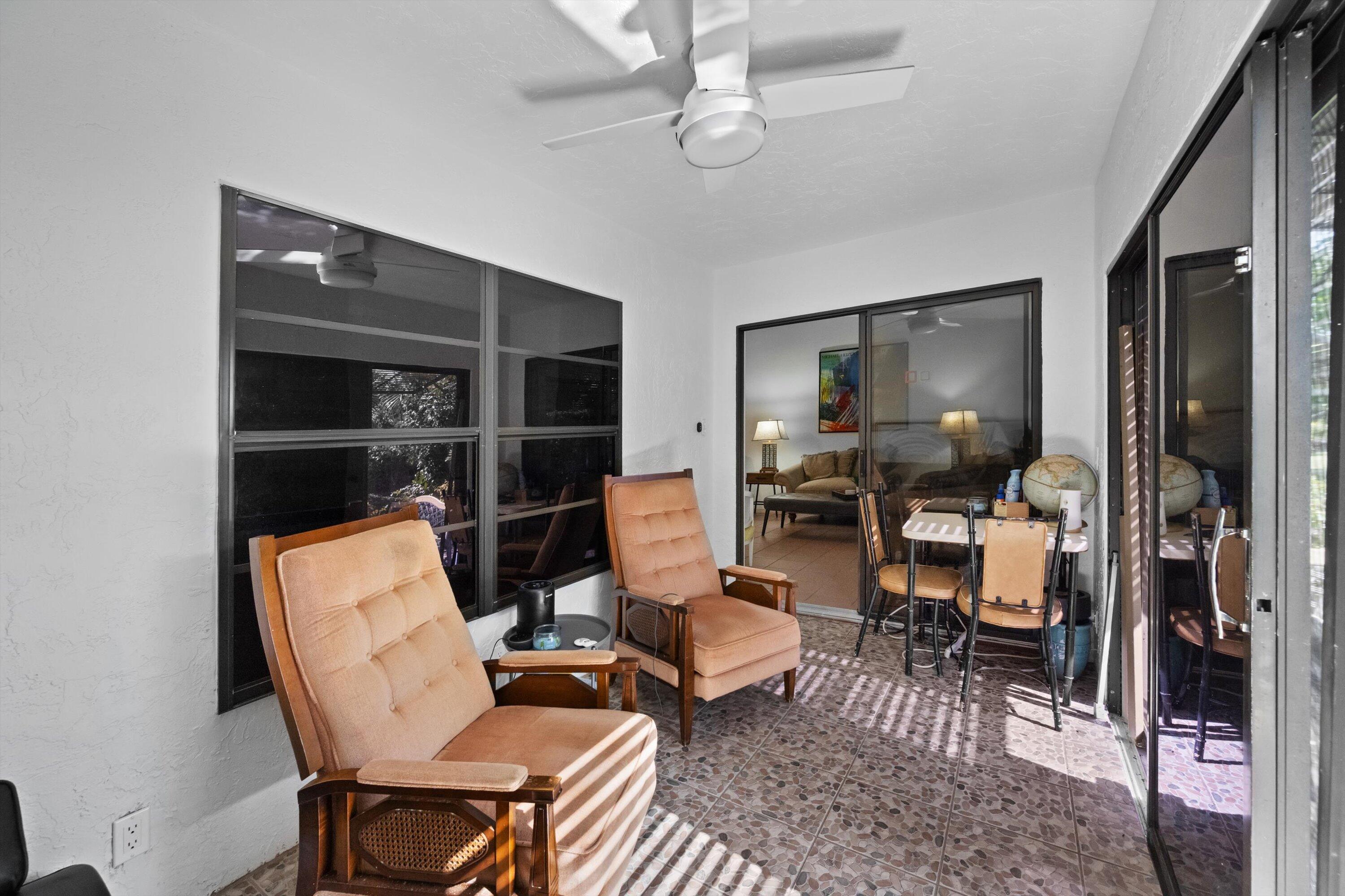 2 Ridge Pointe Drive, Unit A Boynton Beach, FL 33435 - Photo 21 of 24 a living room with furniture a rug and a window