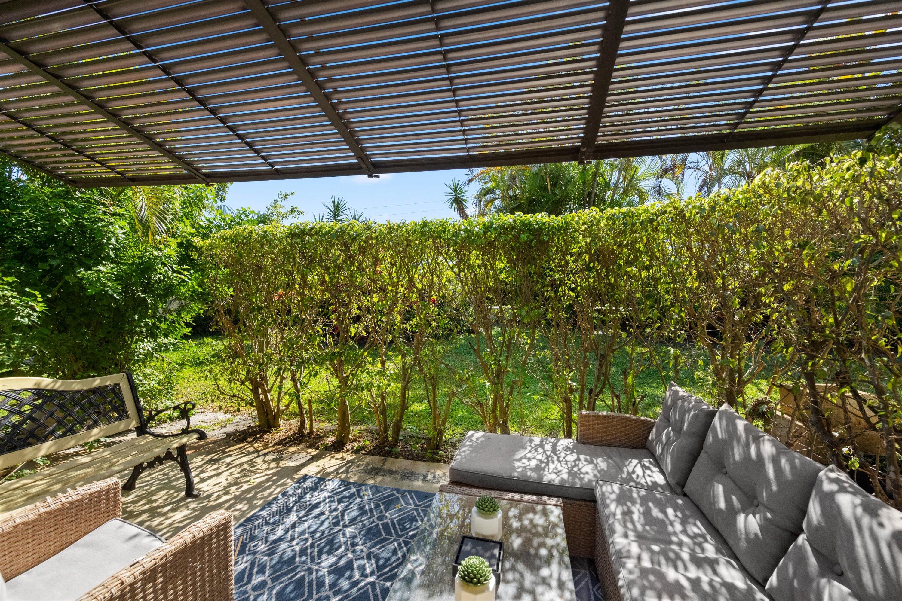 2 Ridge Pointe Drive, Unit A Boynton Beach, FL 33435 - Photo 22 of 24 a backyard of a house with lots of green space