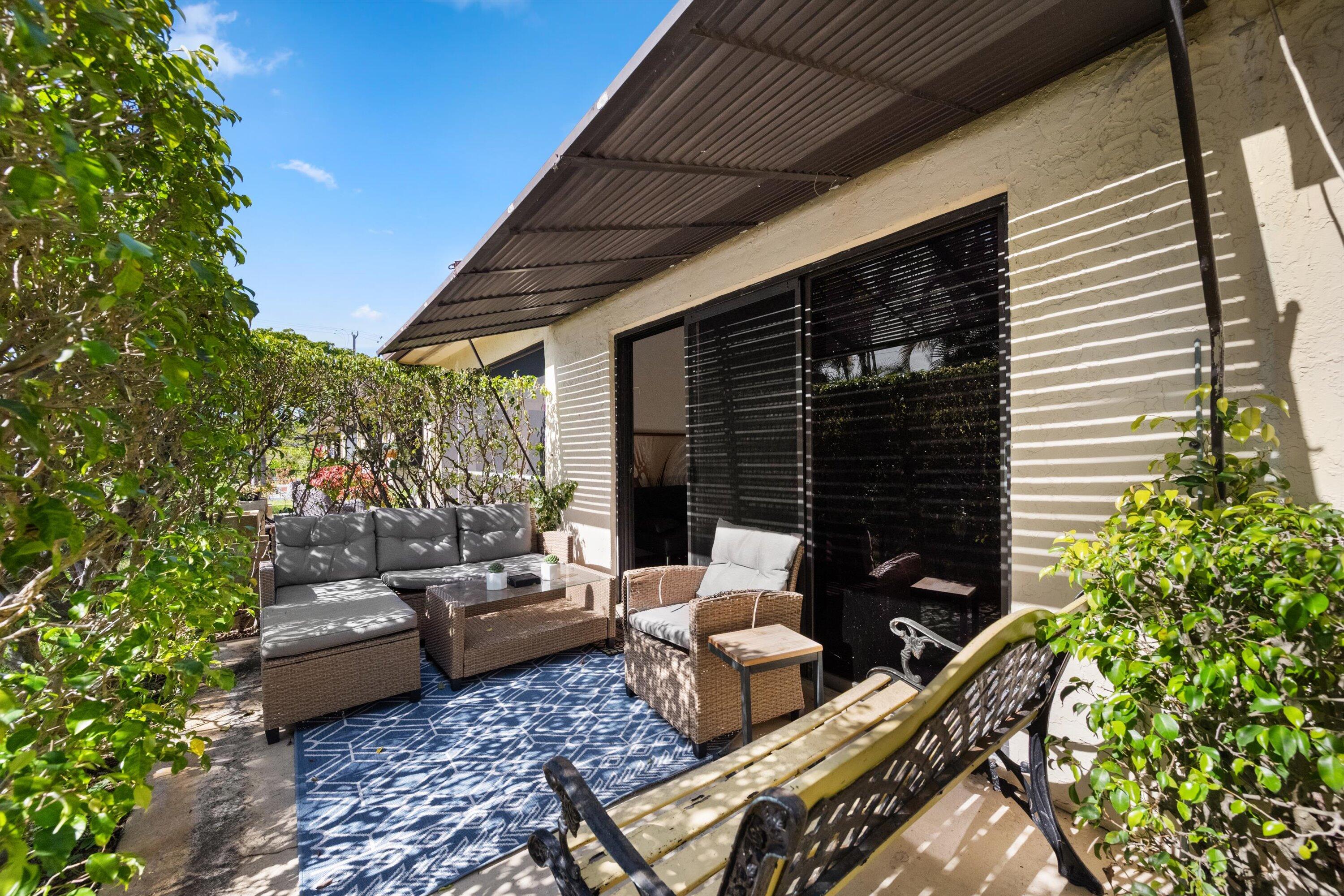 2 Ridge Pointe Drive, Unit A Boynton Beach, FL 33435 - Photo 23 of 24 a backyard of a house with seating space