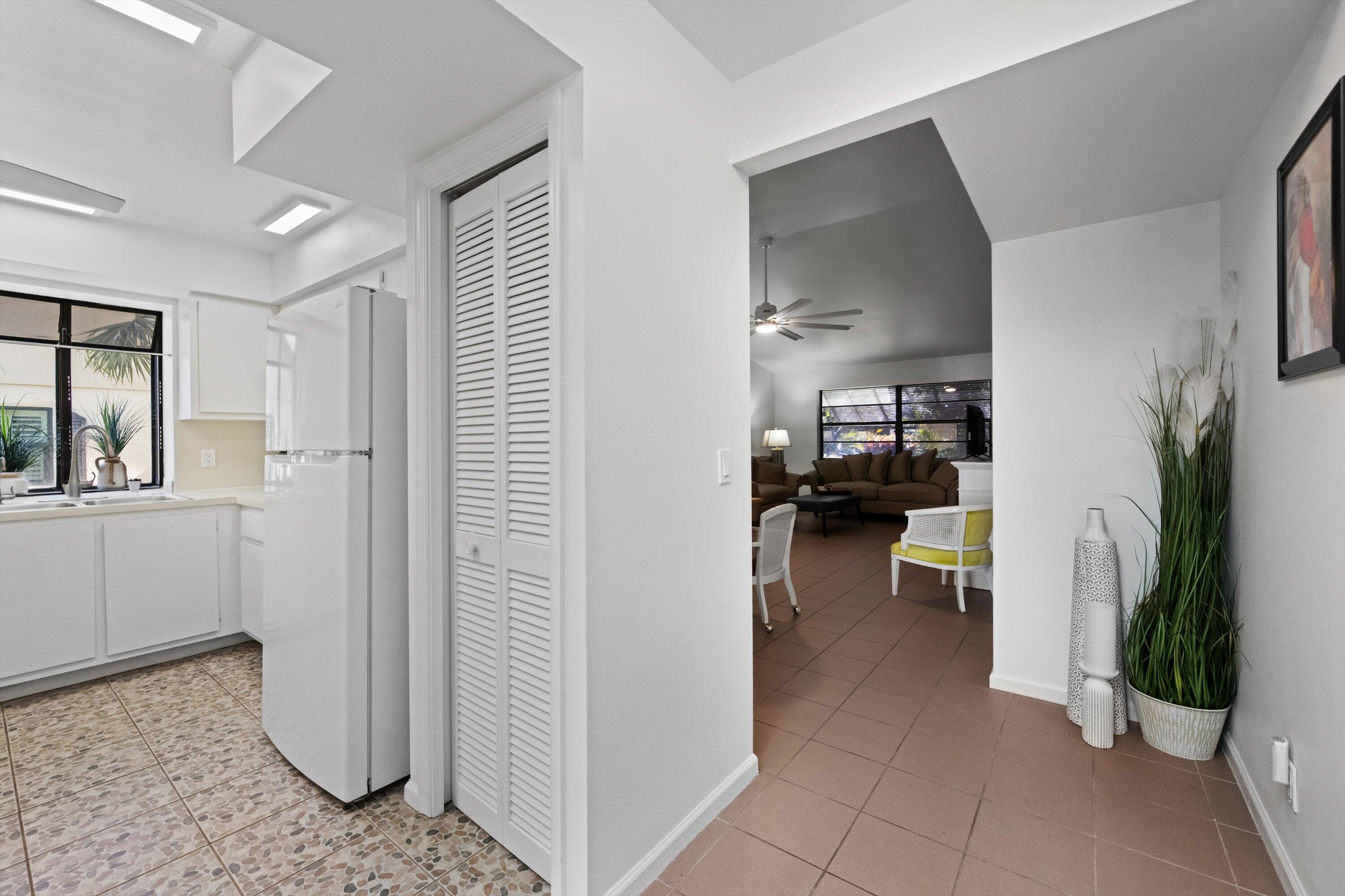 2 Ridge Pointe Drive, Unit A Boynton Beach, FL 33435 - Photo 4 of 24 a view of a hallway with living room and furniture