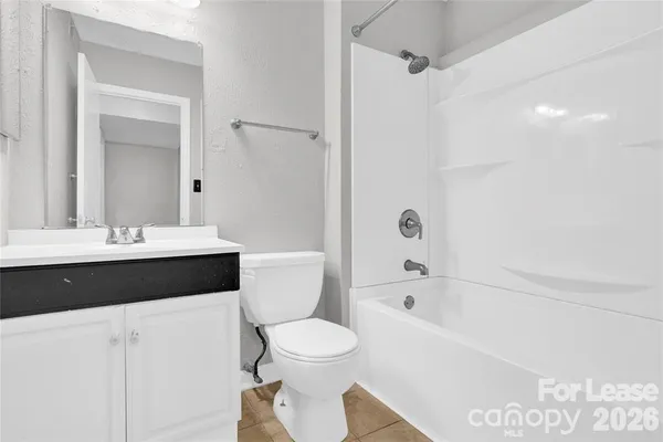 a bathroom with a bathtub shower sink mirror and toilet