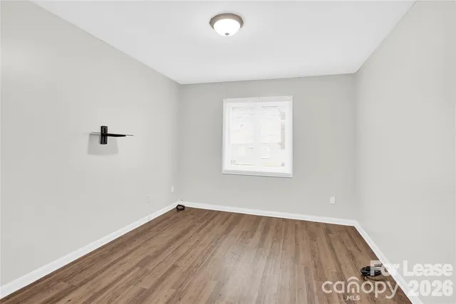 a view of a room with wooden floor and windows