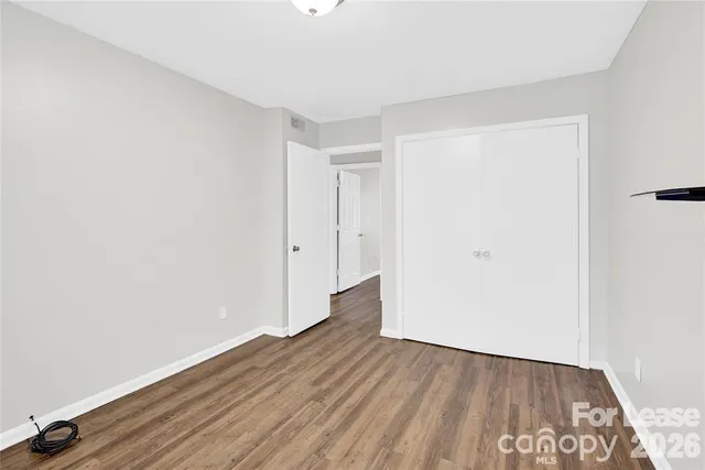 an empty room with wooden floor