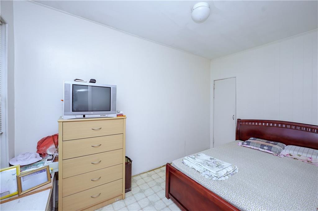 1216 Tabor Court Brooklyn, NY 11219 - Photo 9 of 20 a bedroom with a bed and chair