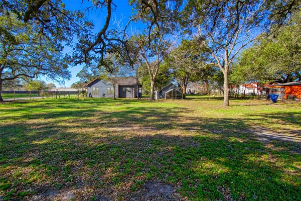 a backyard of a house with lots of green space and trees