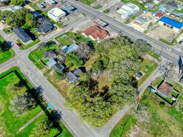 an aerial view of house with a tennis court