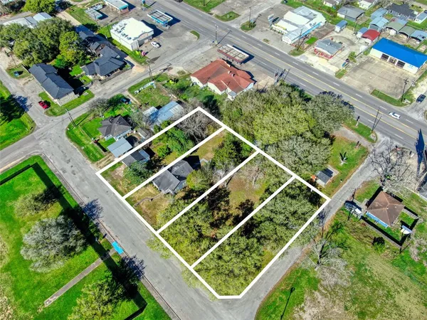 an aerial view of a residential houses with street