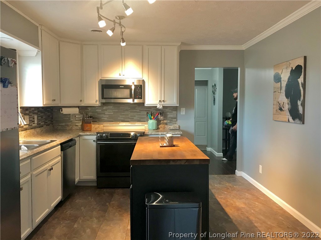172 Tarheel Road Lumberton, NC 28358 - Photo 5 of 34 a kitchen with stainless steel appliances granite countertop a sink stove and refrigerator