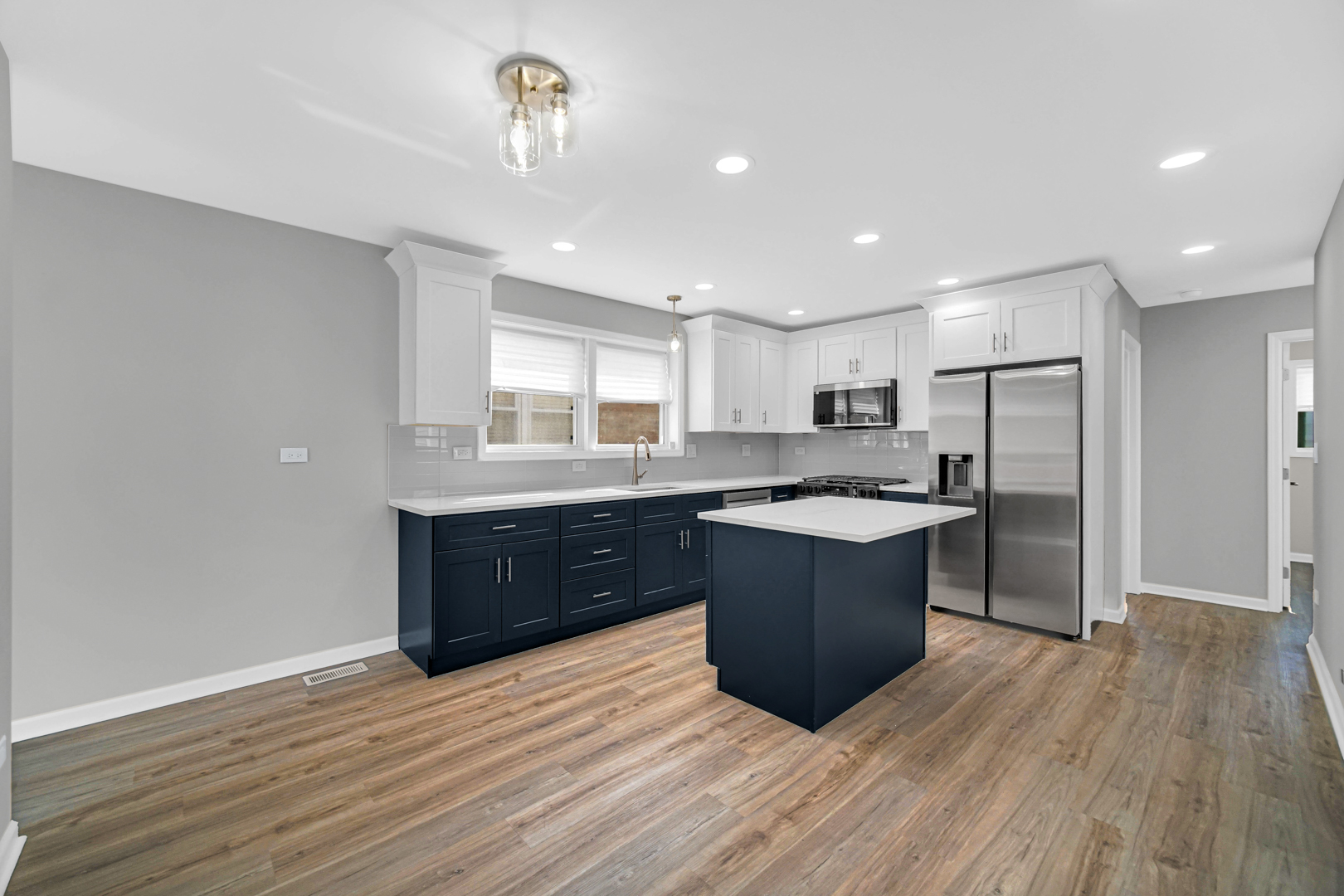 3629 West 84th Street Chicago, IL 60652 - Photo 6 of 23 a large kitchen with a large counter top a sink stainless steel appliances and cabinets