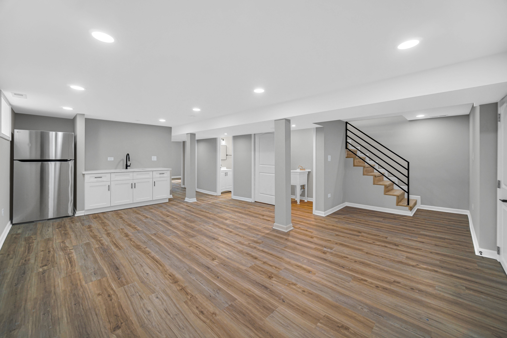 3629 West 84th Street Chicago, IL 60652 - Photo 10 of 23 a view of an empty room with wooden floor and kitchen space