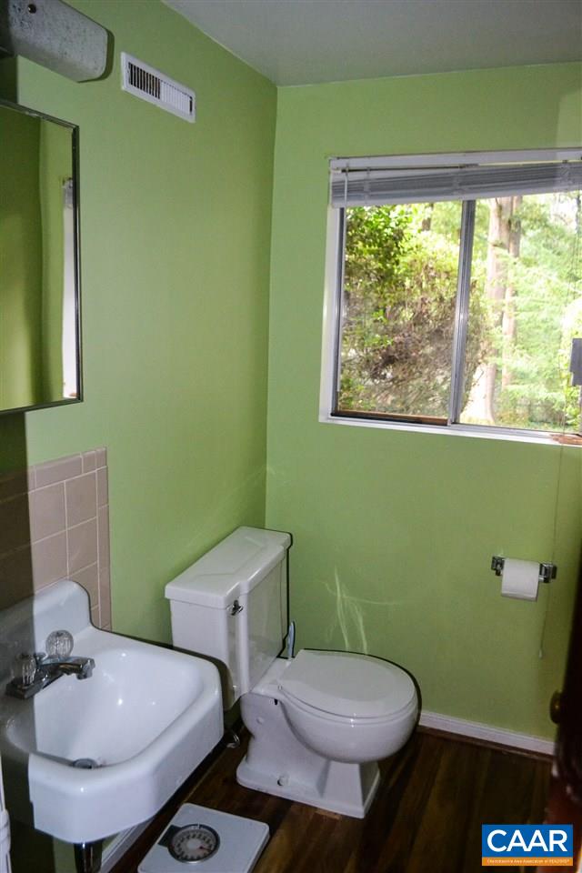 703 Shamrock Road Charlottesville, VA 22903 - Photo 23 of 36 a bathroom with a toilet sink and mirror