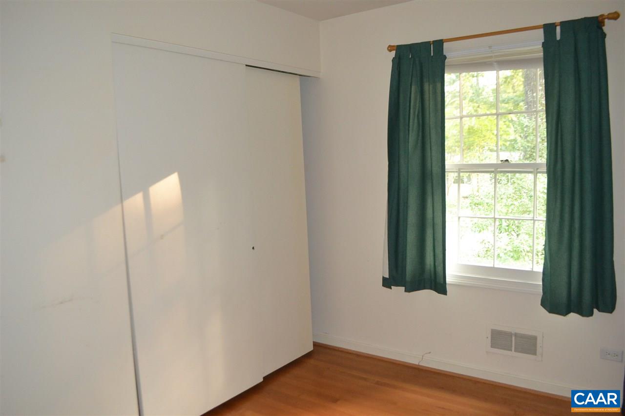 703 Shamrock Road Charlottesville, VA 22903 - Photo 27 of 36 a view of an empty room with wooden floor and a window