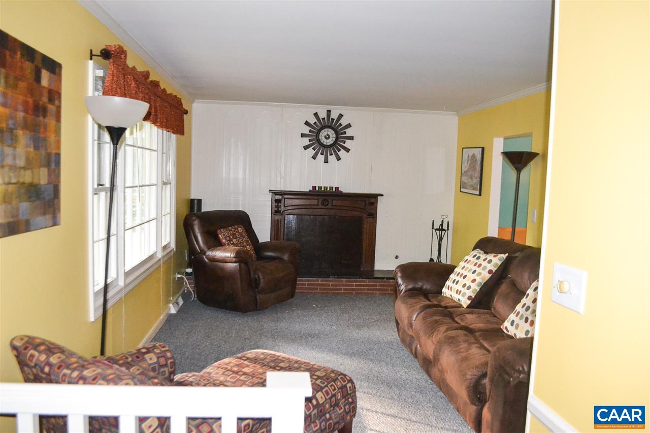 703 Shamrock Road Charlottesville, VA 22903 - Photo 7 of 36 a living room with furniture and a fireplace