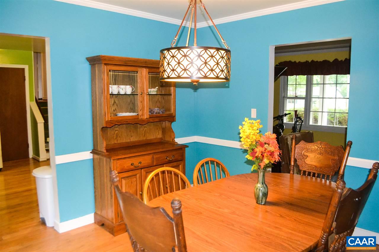 703 Shamrock Road Charlottesville, VA 22903 - Photo 10 of 36 a view of a dining room with furniture a chandelier and wooden floor