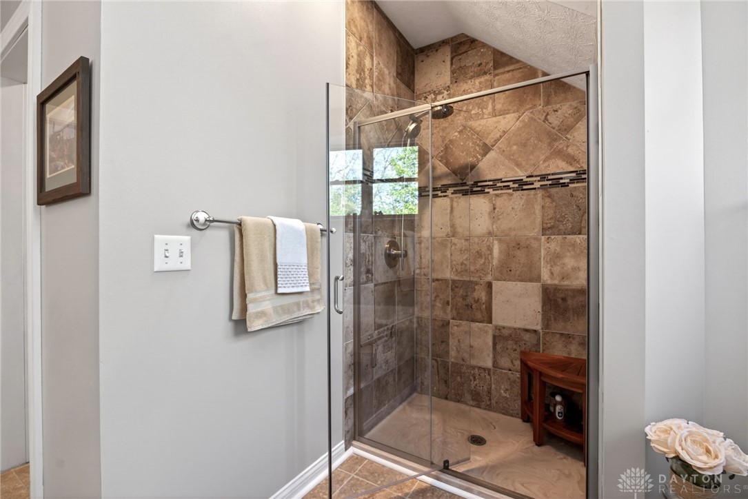330 South Alpha Bellbrook Road Bellbrook, OH 45305 - Photo 44 of 87 This tiled shower with glass enclosure offers a refreshing daily retreat.