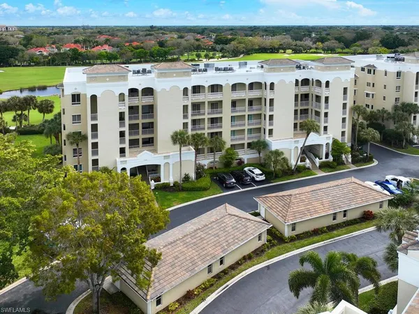 an aerial view of multiple houses with a yard