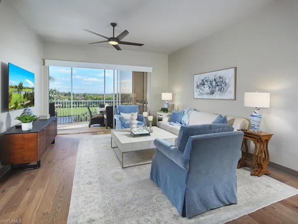 a living room with furniture and a large window