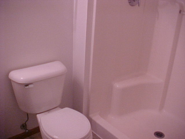 2000 Trillium Trail, Unit B Poplar Grove, IL 61065 - Photo 11 of 12 a white toilet sitting next to a shower
