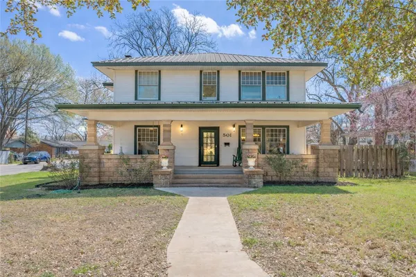 a front view of a house with a yard and porch