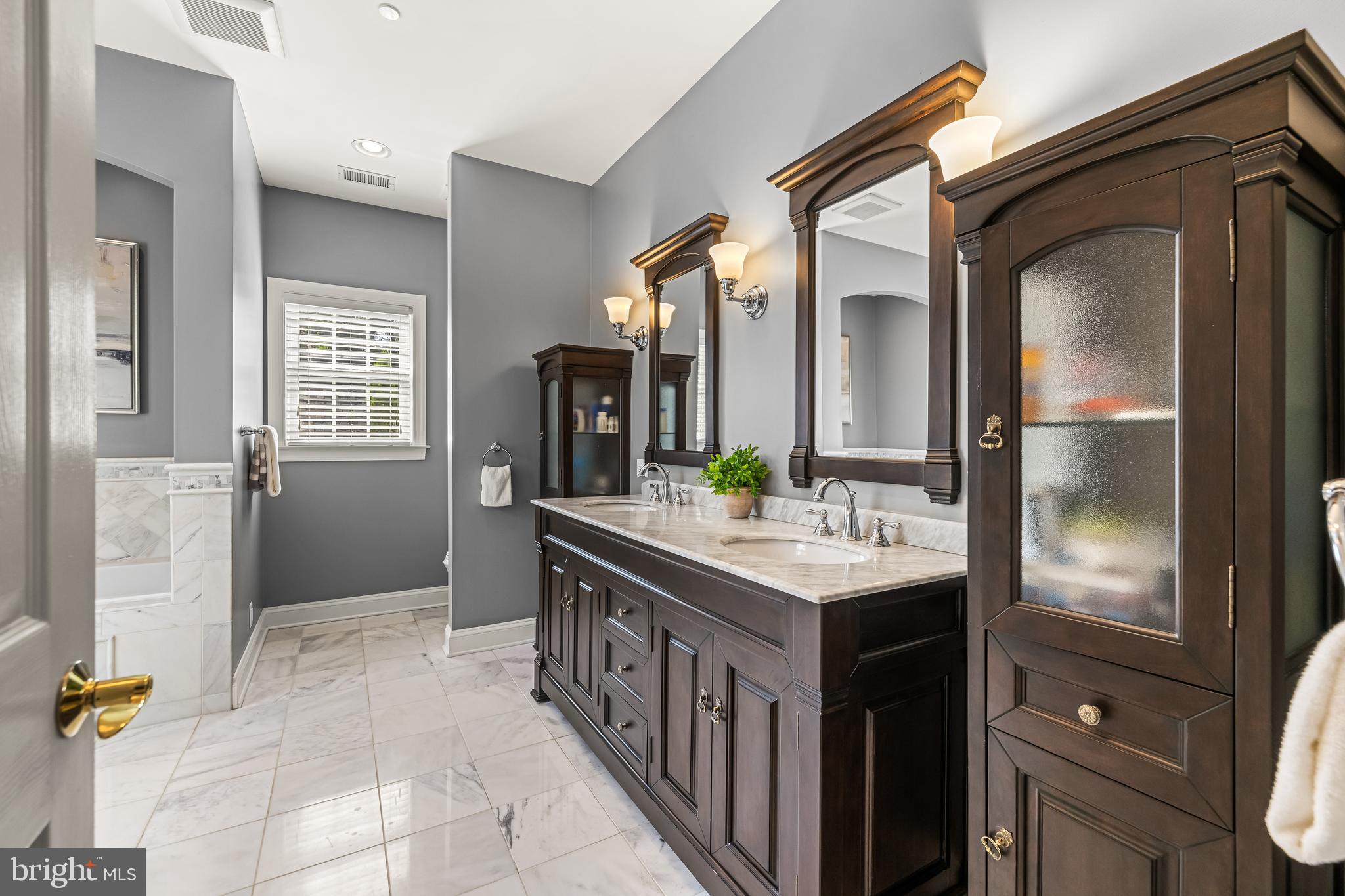 12519 Falls Road Cockeysville, MD 21030 - Photo 45 of 71 a bathroom with a sink a mirror and a shower