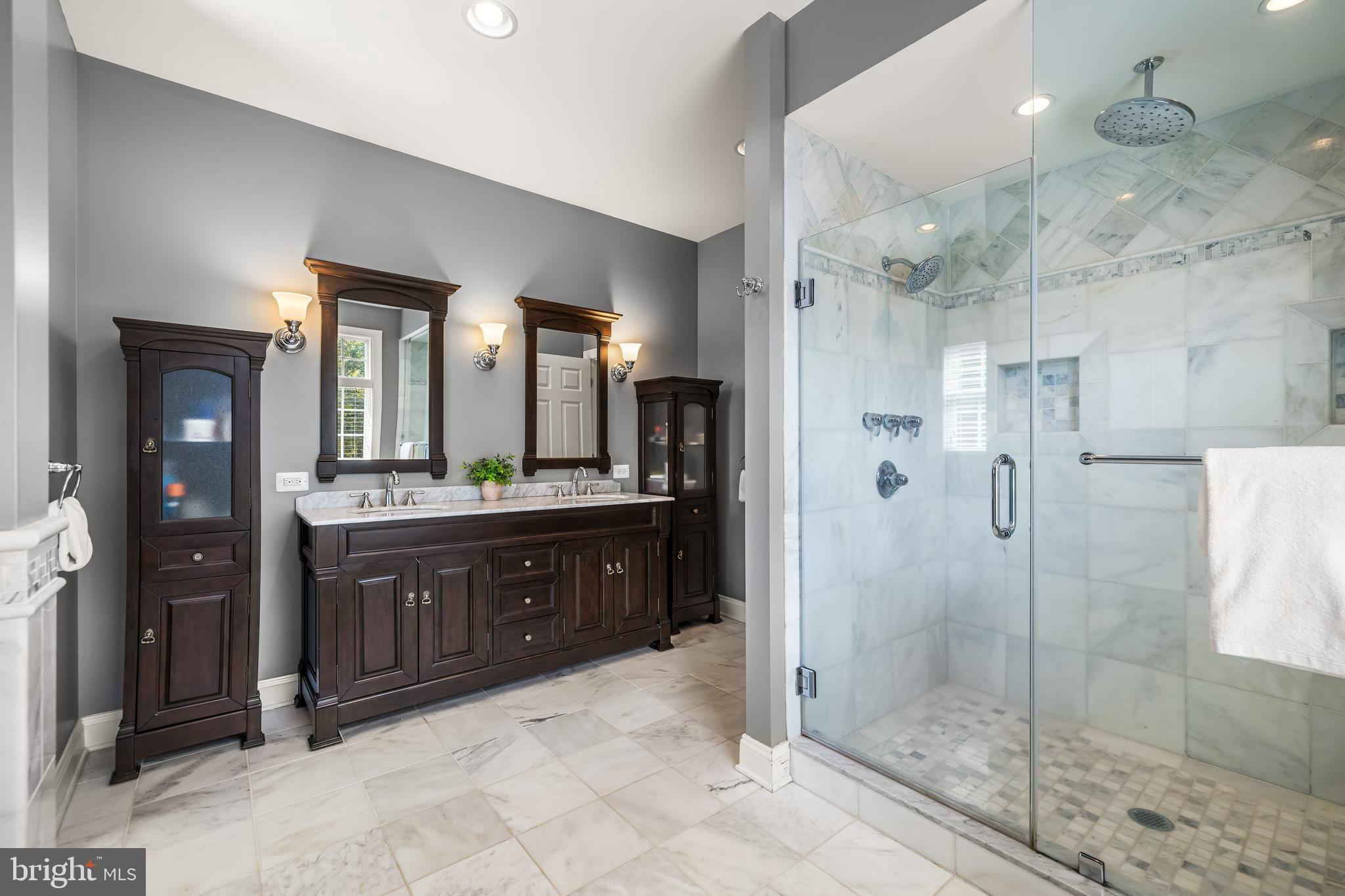 12519 Falls Road Cockeysville, MD 21030 - Photo 46 of 71 a bathroom with a granite countertop sink mirror and shower