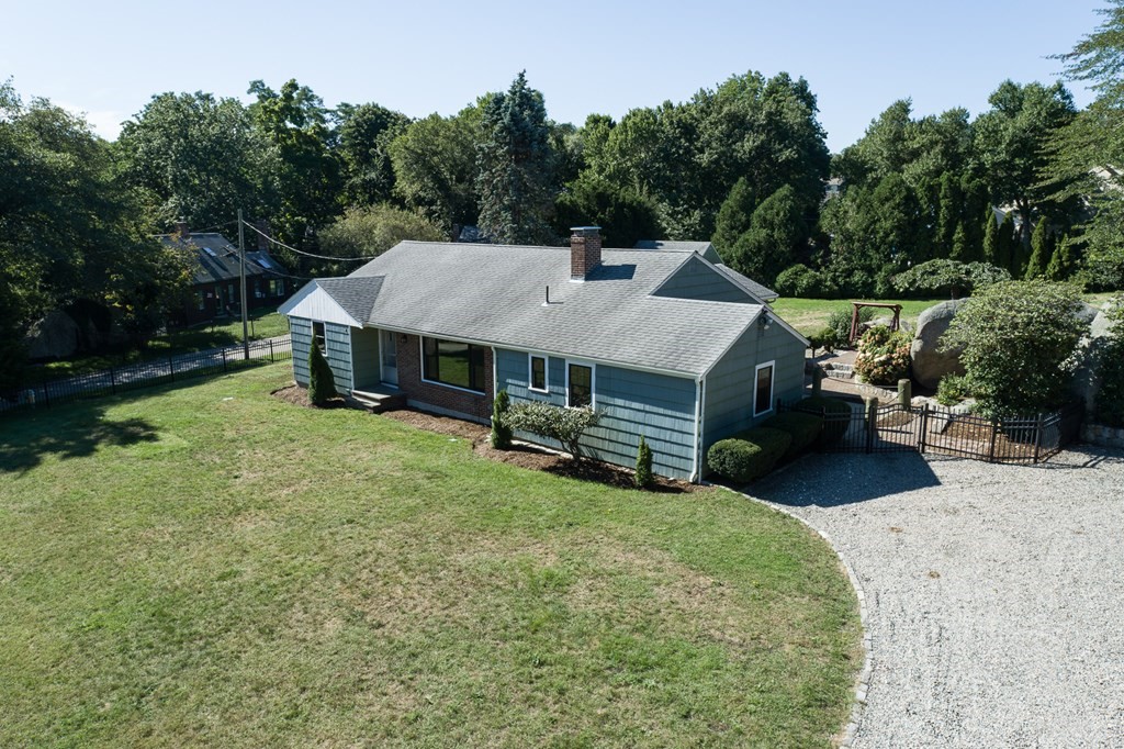 an aerial view of a house with a yard patio and deck