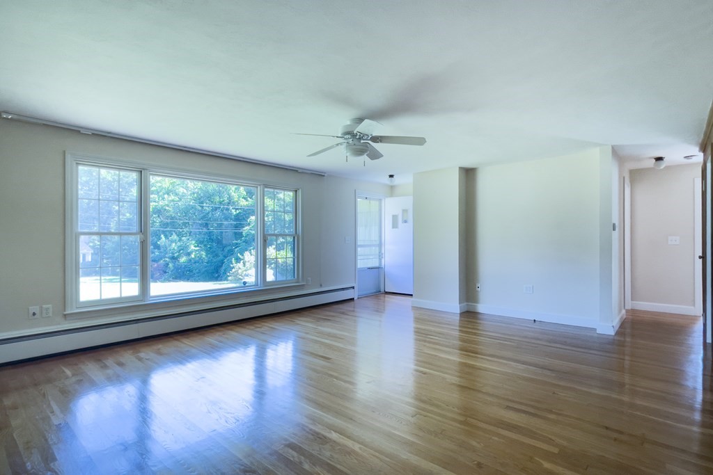 20 Locust Road Cohasset, MA 02025 - Photo 19 of 41 a view of a livingroom with wooden floor and a ceiling fan