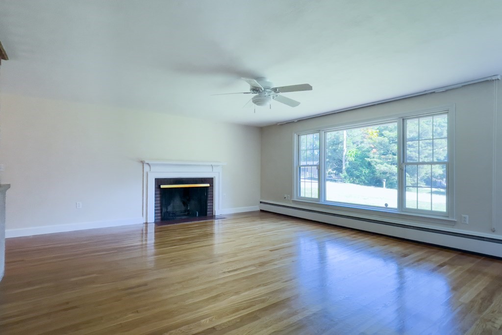 20 Locust Road Cohasset, MA 02025 - Photo 20 of 41 a view of a room with wooden floor and fireplace
