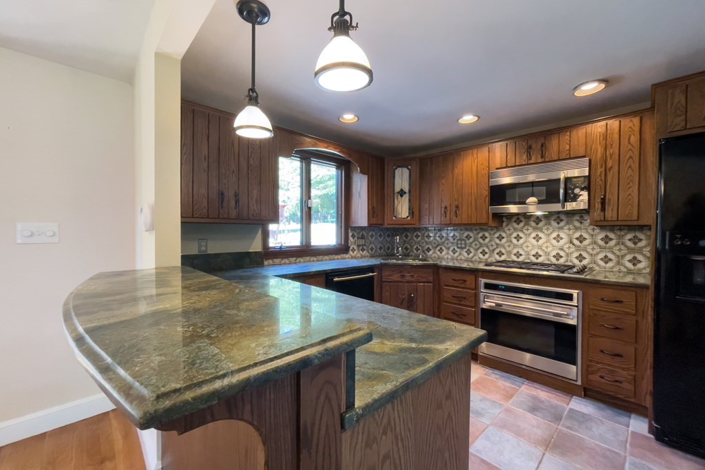20 Locust Road Cohasset, MA 02025 - Photo 24 of 41 a kitchen with stainless steel appliances granite countertop a sink counter space cabinets and furniture