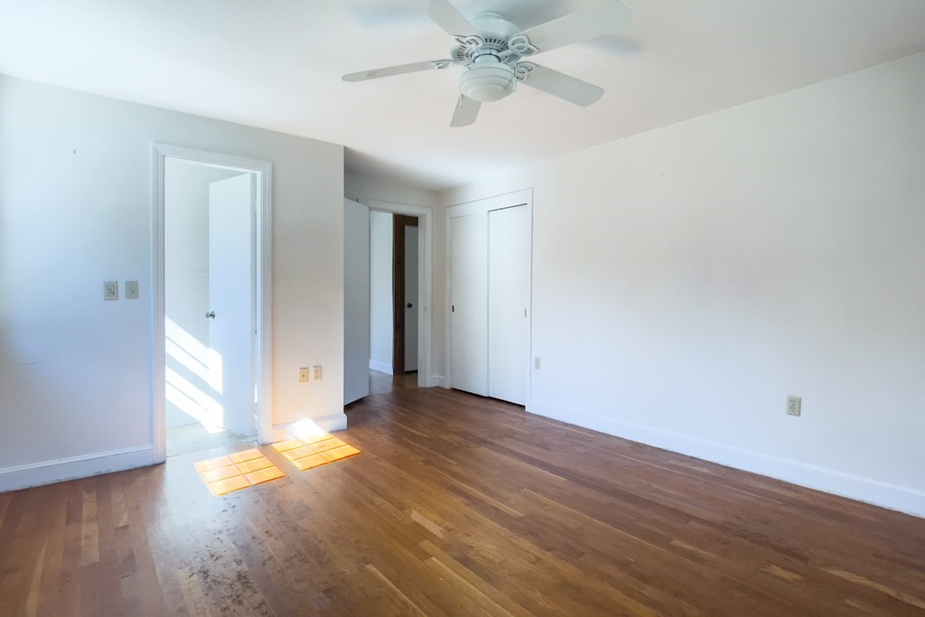20 Locust Road Cohasset, MA 02025 - Photo 30 of 41 an empty room with wooden floor and door