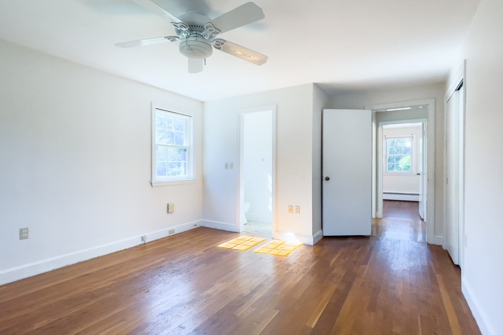 20 Locust Road Cohasset, MA 02025 - Photo 31 of 41 an empty room with wooden floor ceiling fan and windows