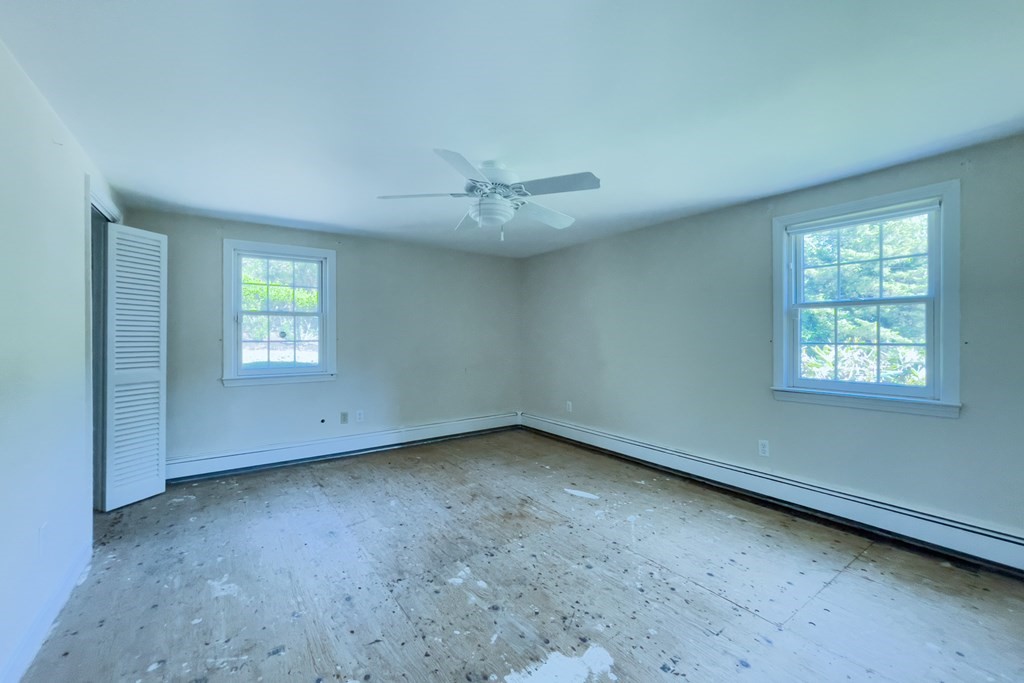 20 Locust Road Cohasset, MA 02025 - Photo 36 of 41 an empty room with a ceiling fan and window