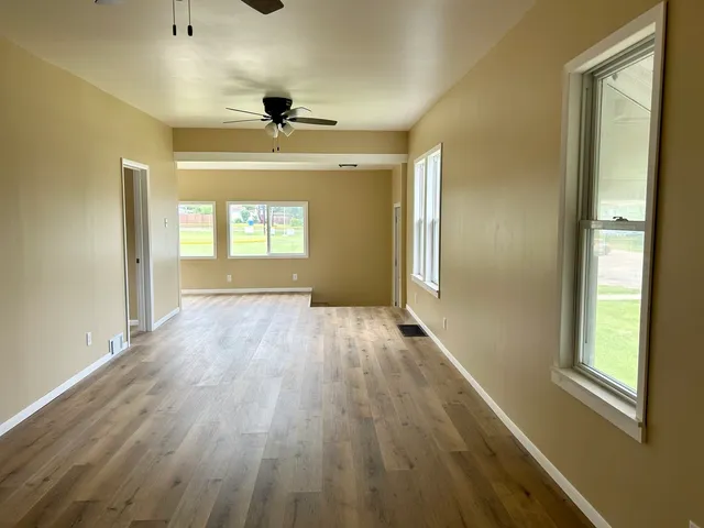 wooden floor in an empty room with a window
