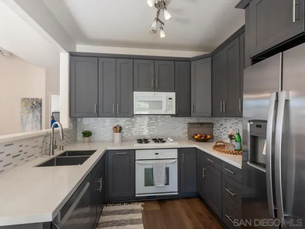 a kitchen with a sink stove a sink and refrigerator