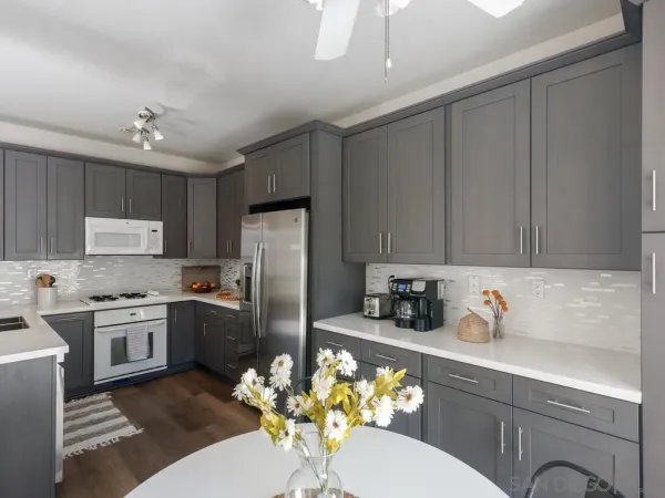 a kitchen with stainless steel appliances granite countertop a refrigerator sink stove microwave and cabinets