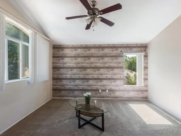 a view of room with a window and a ceiling fan